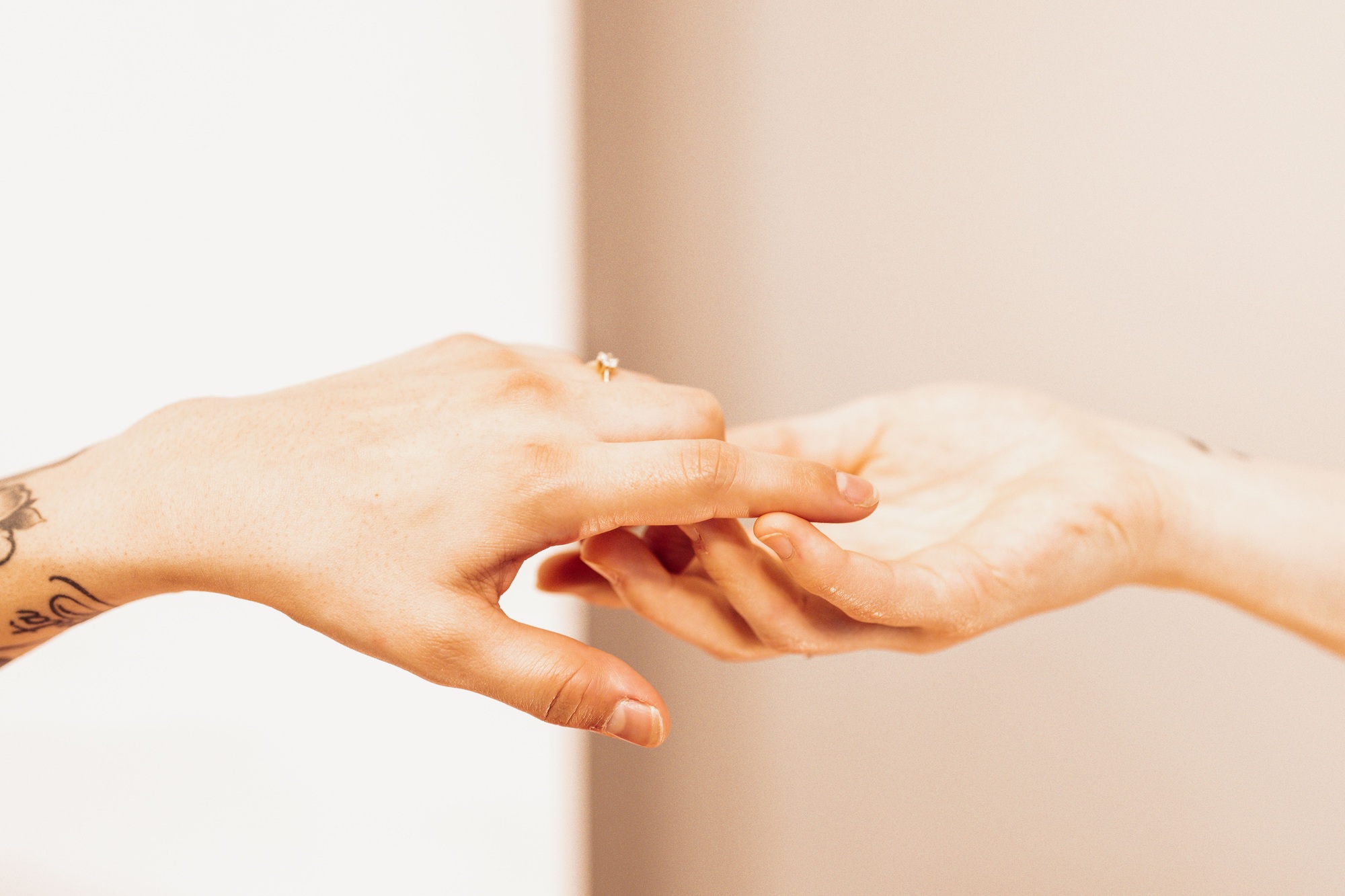 Two female hands touching gently
